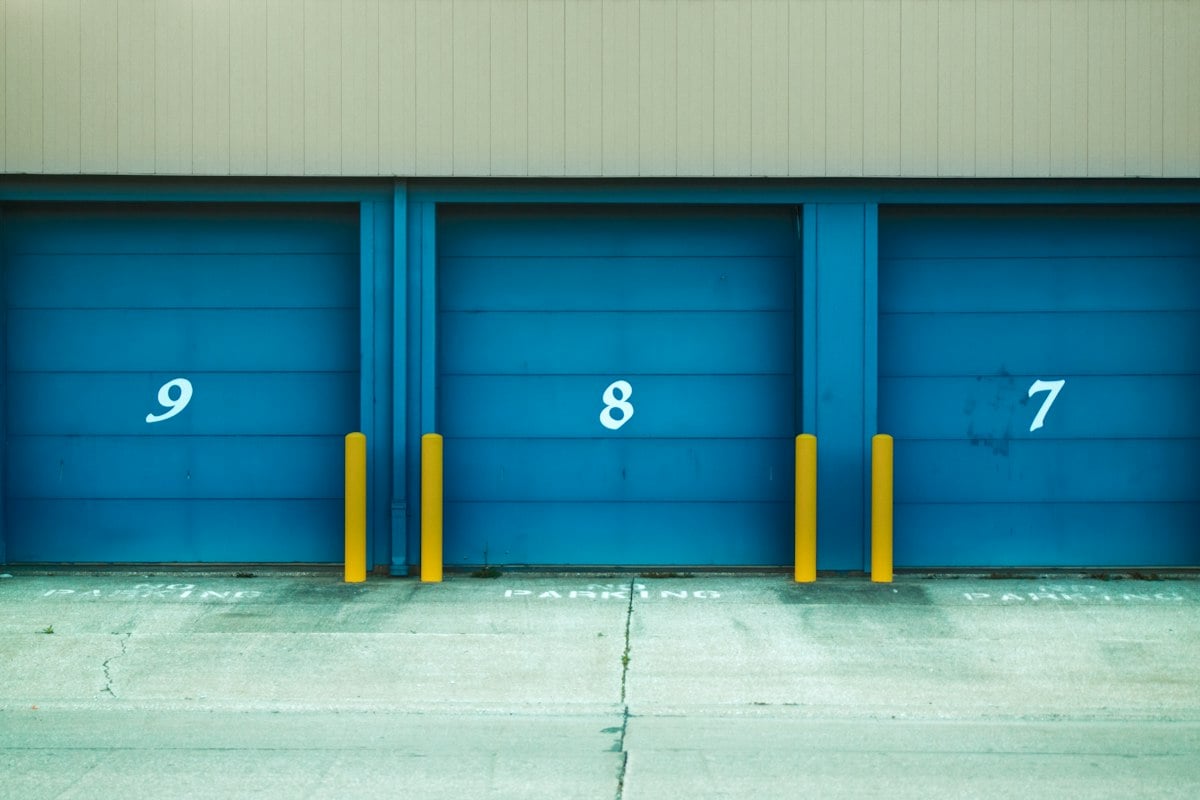 Numbered blue roller doors on a commercial bay