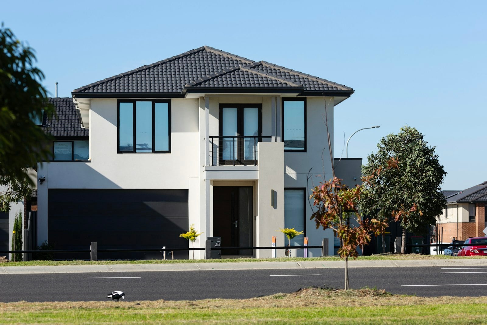 Two-story house with a wide dark garage door