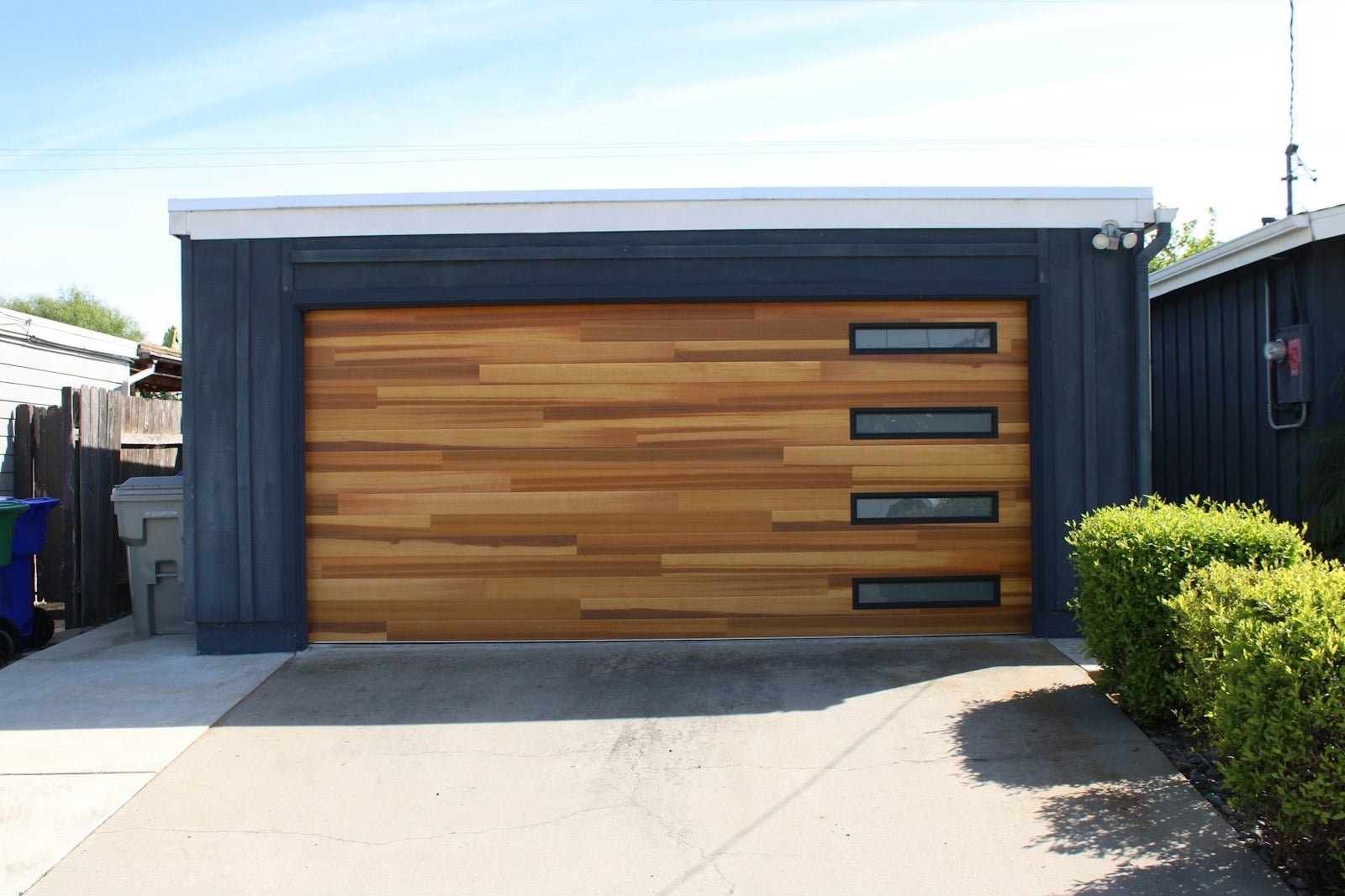 Wood-look garage door with a row of narrow windows